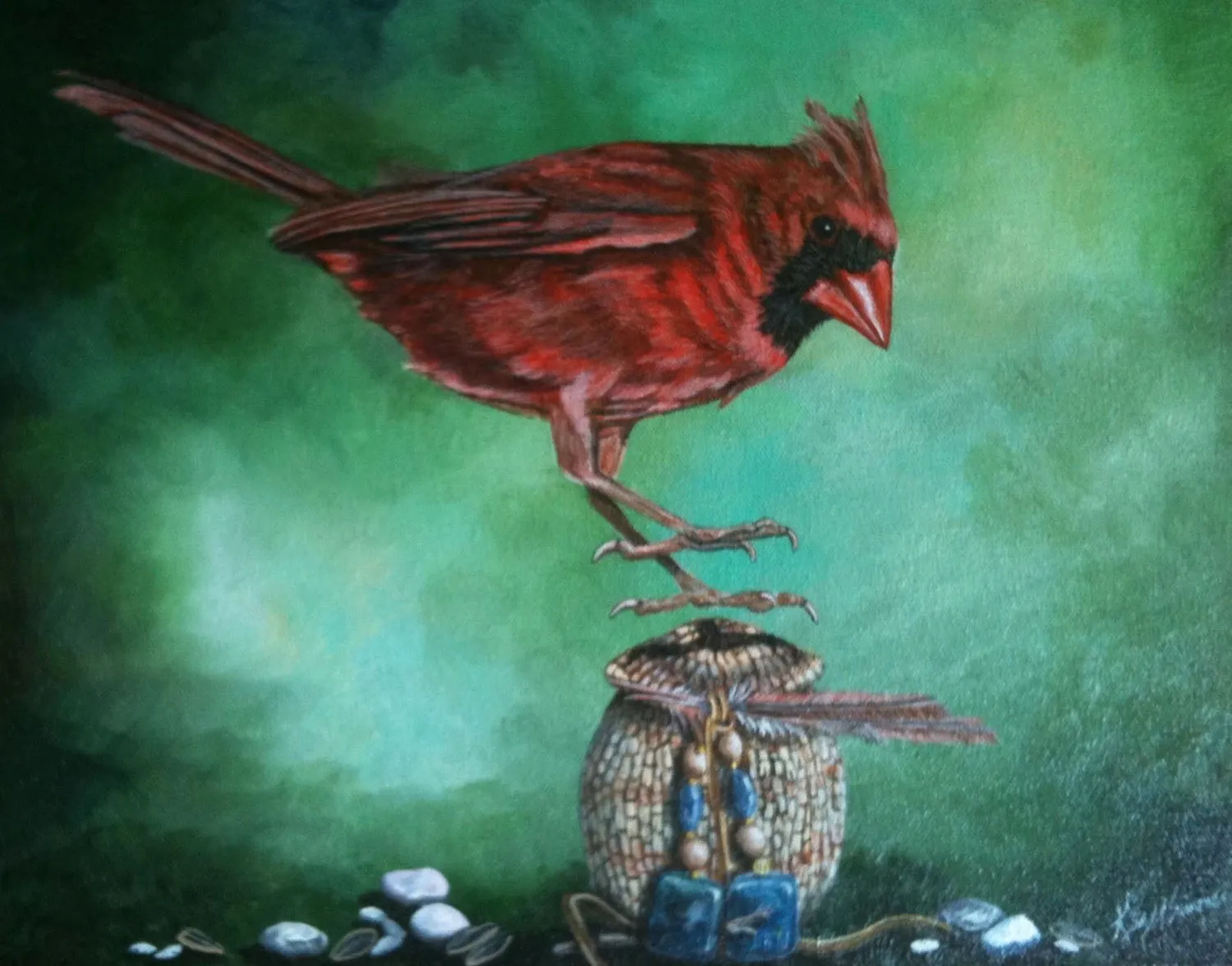 A male Northern Cardinal perching on a woven pouch with blue beads and feathers.