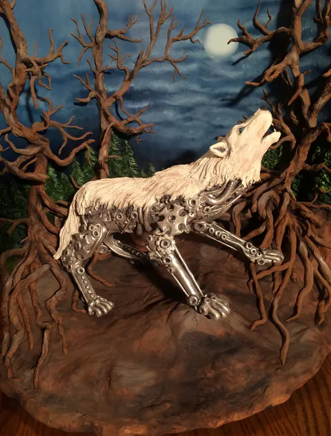 Steampunk wolf cake diorama with a white wolf howling at the moon with clockwork lower body.