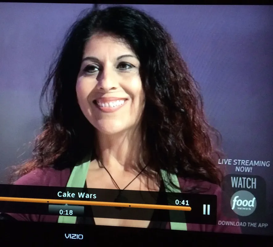 Kim Simons in a paused video frame from Cake Wars on Food Network.