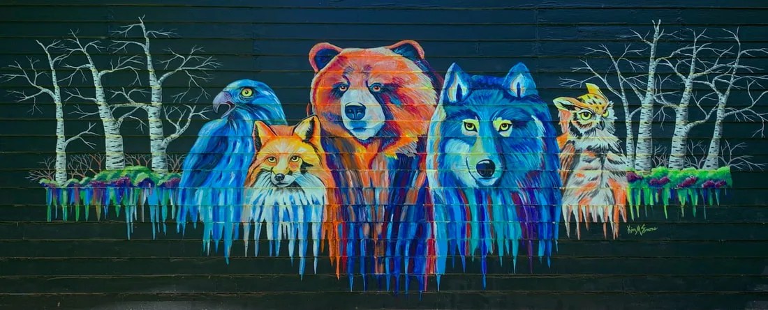 Mural of forest animals on a dark wooden wall.
