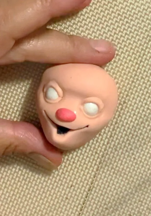 White fondant eyes and a pink oval nose added to the scarecrow face.