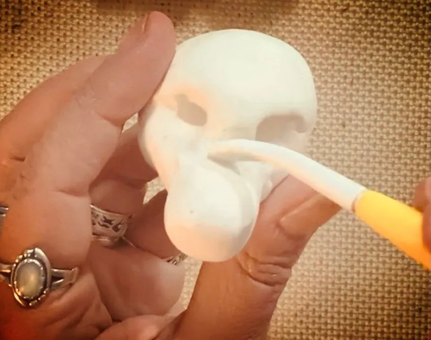 Shaping the bear snout with a cake tool on the head.
