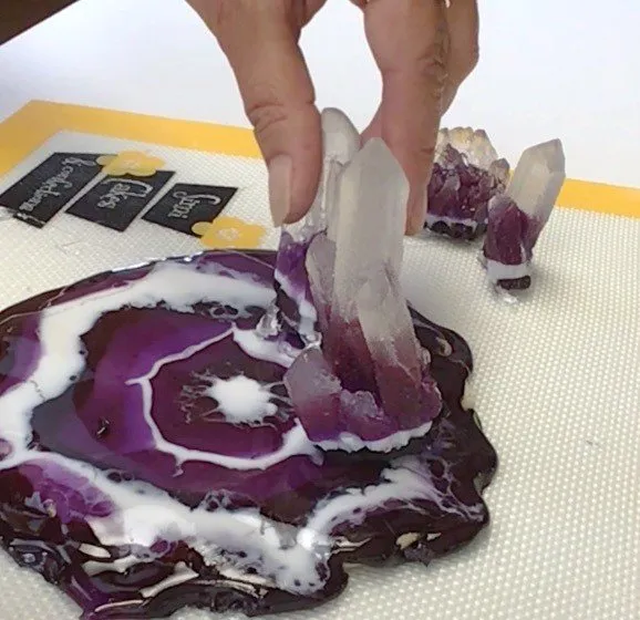 Attaching isomalt crystals to the geode cookie base with clear isomalt.