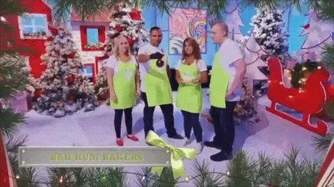 The Bah Hum Bakers team in lime green aprons on the Holiday Wars set.