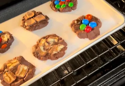 Baking sheet of cookies with candy toppings in the oven