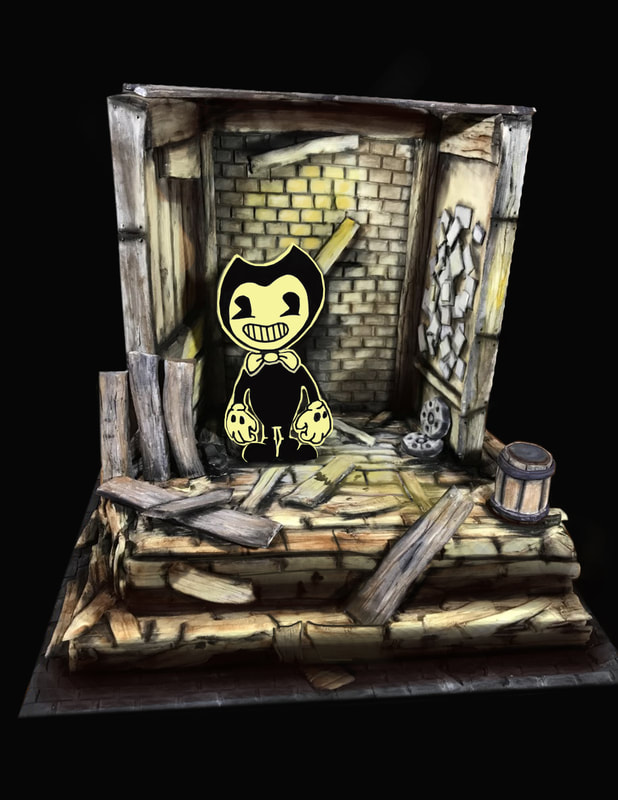 A sculpted cake diorama featuring the character Bendy from the game Bendy and the Ink Machine standing amidst a dilapidated, wooden room with broken planks and exposed brick walls.