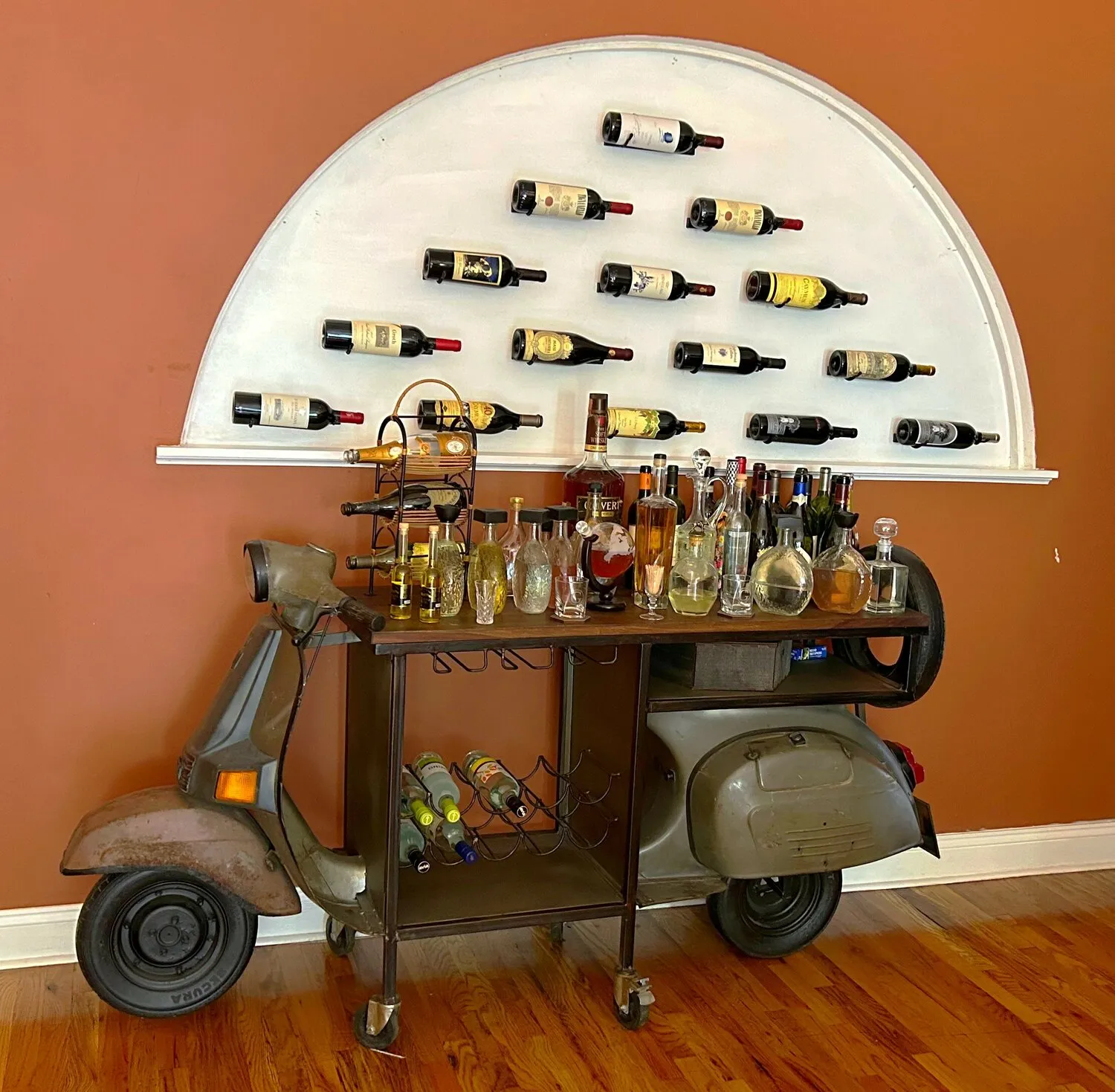 A repurposed scooter bar cart stocked with liquor and wine bottles at Solaia Restaurant.