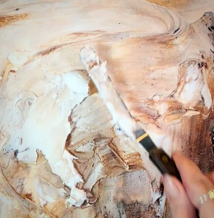 Spreading buttercream icing onto the cake.