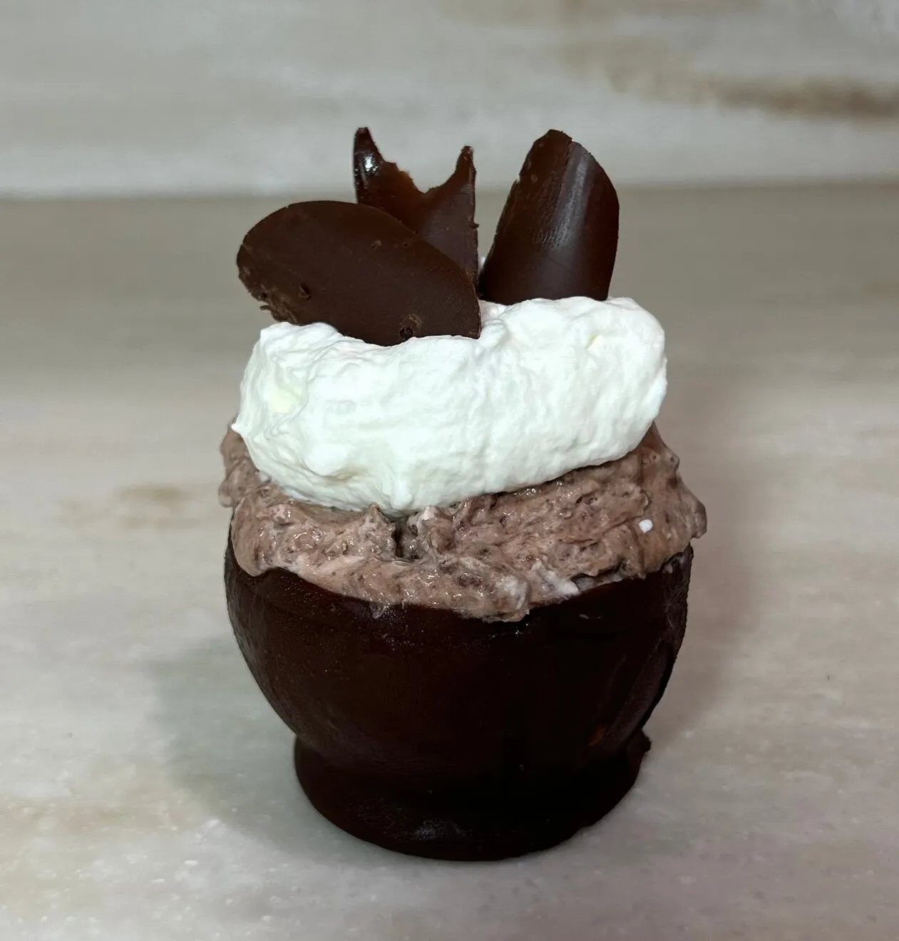 Chocolate cups filled with chocolate mousse ready to be served
