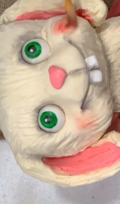 Close-up of the bunny face with green irises, pink nose, and ears.