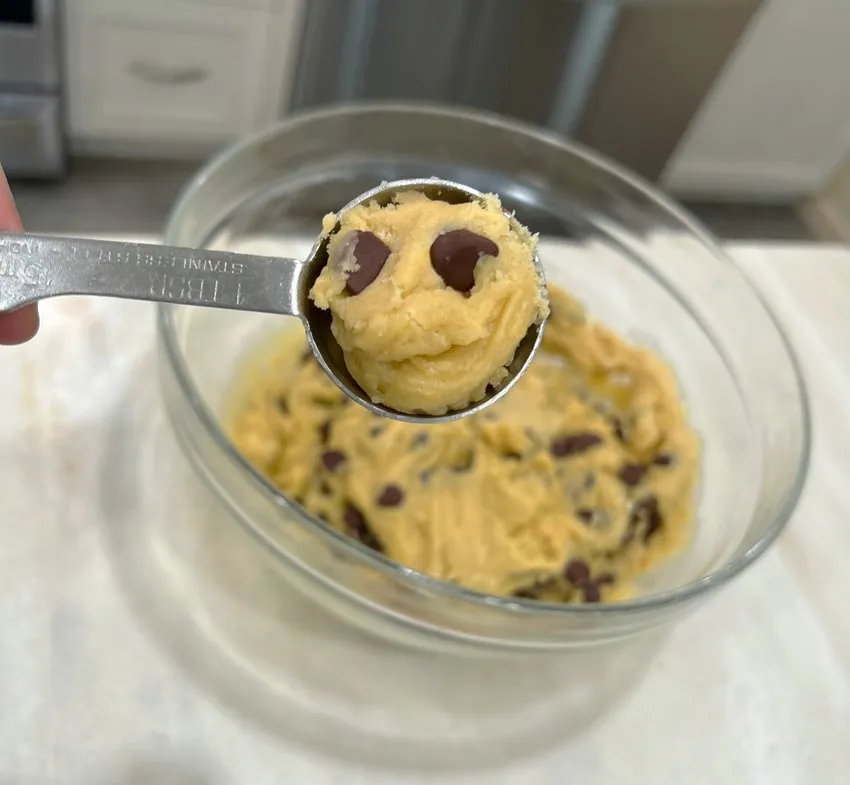 Scooping cookie dough with a tablespoon measure