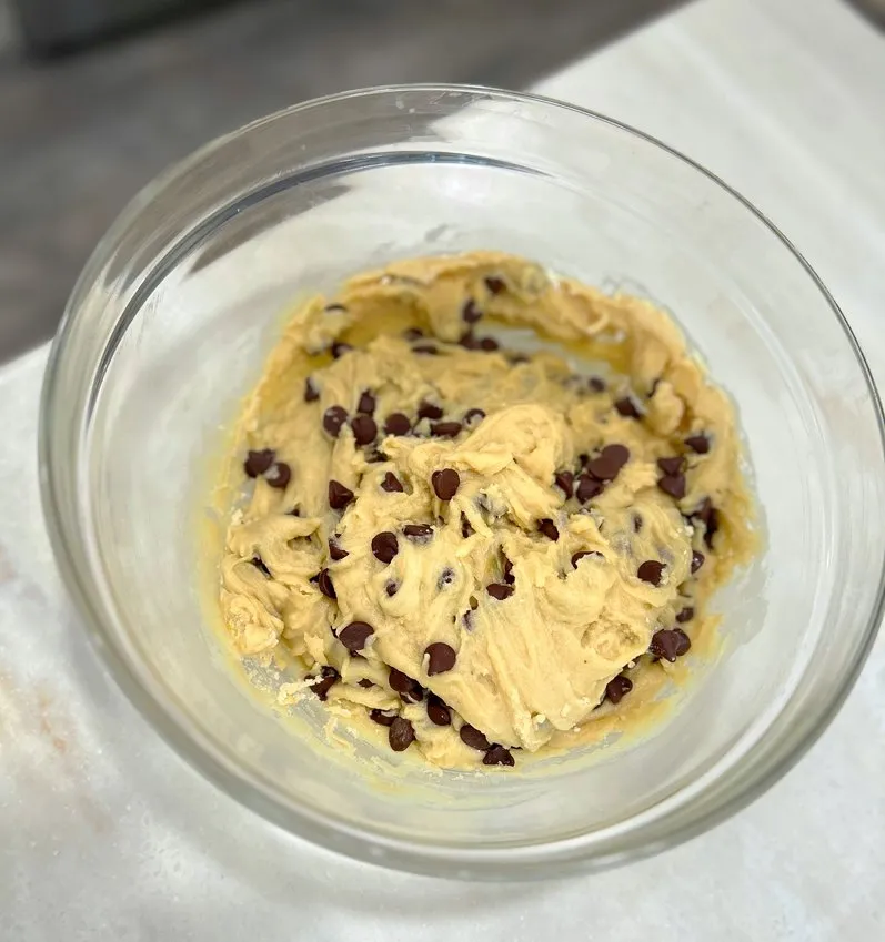 Chocolate chip cookie dough in a glass bowl