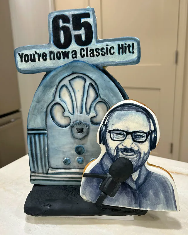 Hand-painted 65th birthday cookie featuring a classic hit radio theme for Paul Ciliberto.