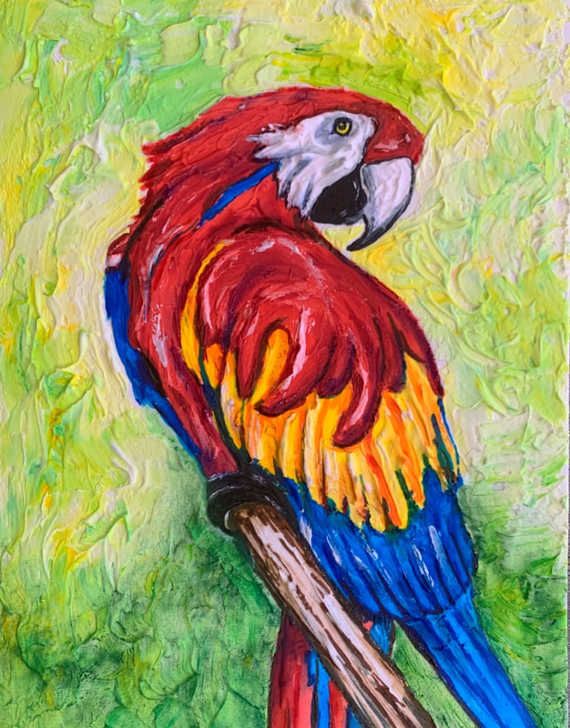 A vibrant, textured sugar painting of a red-and-blue macaw perched on a branch against a swirled green and yellow background.