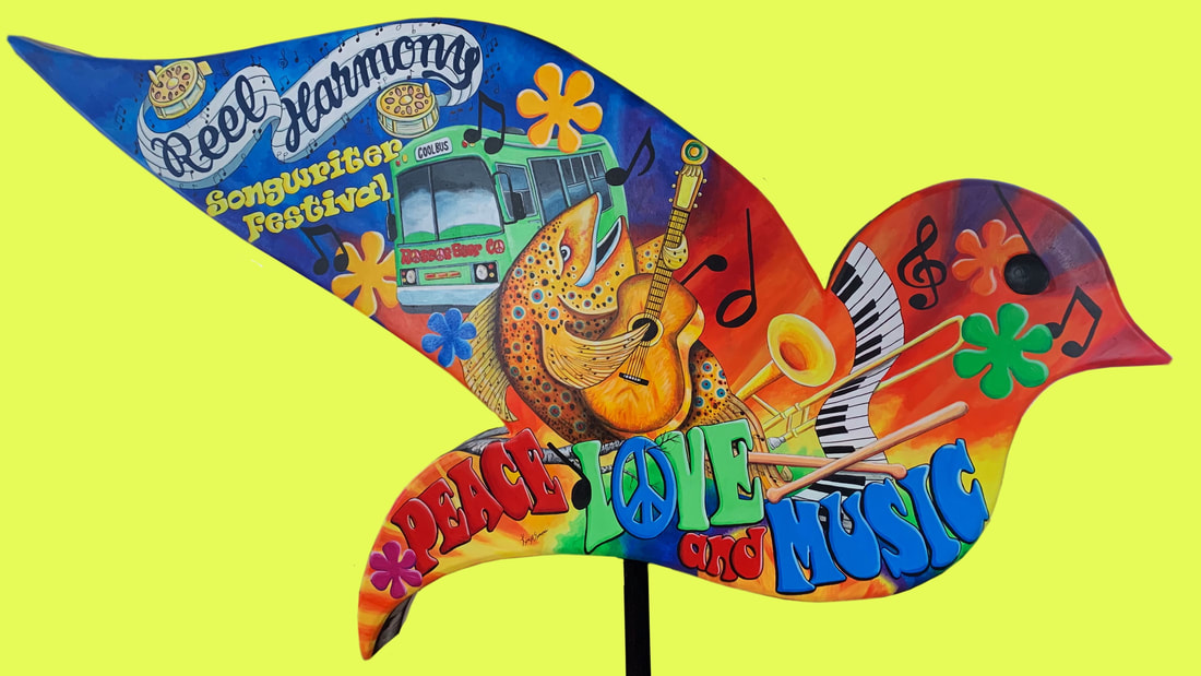 A colorful, psychedelic wooden bird sculpture painted with peace signs, flowers, and the word "LIBERTY" in bold letters, set against a vibrant red background.