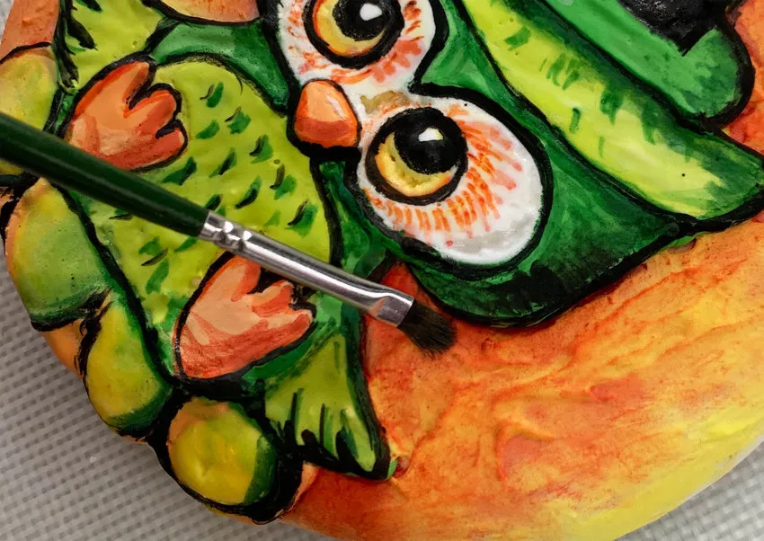 Dusting highlights and shadows onto the owl cookie.