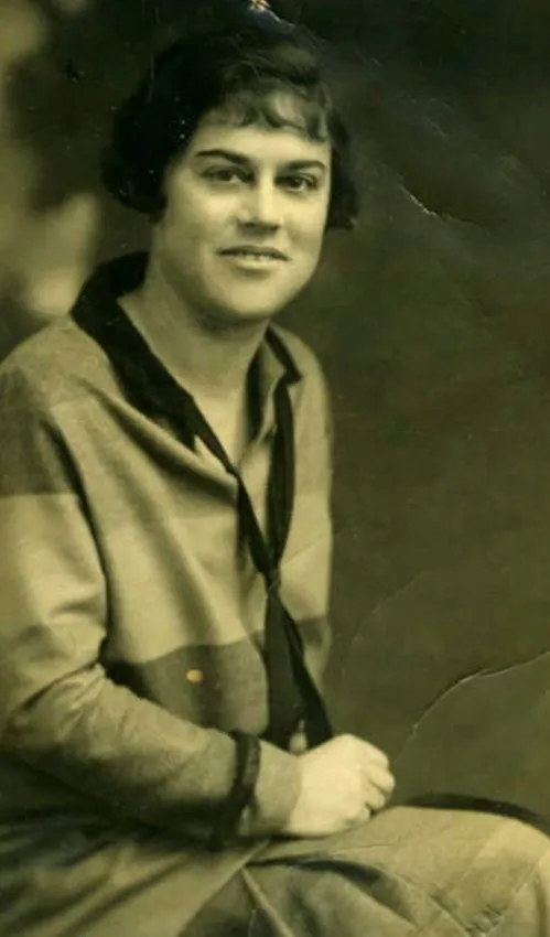 Sepia-toned vintage portrait of Evelyn, Kim's grandmother, in a light-colored dress and dark scarf.