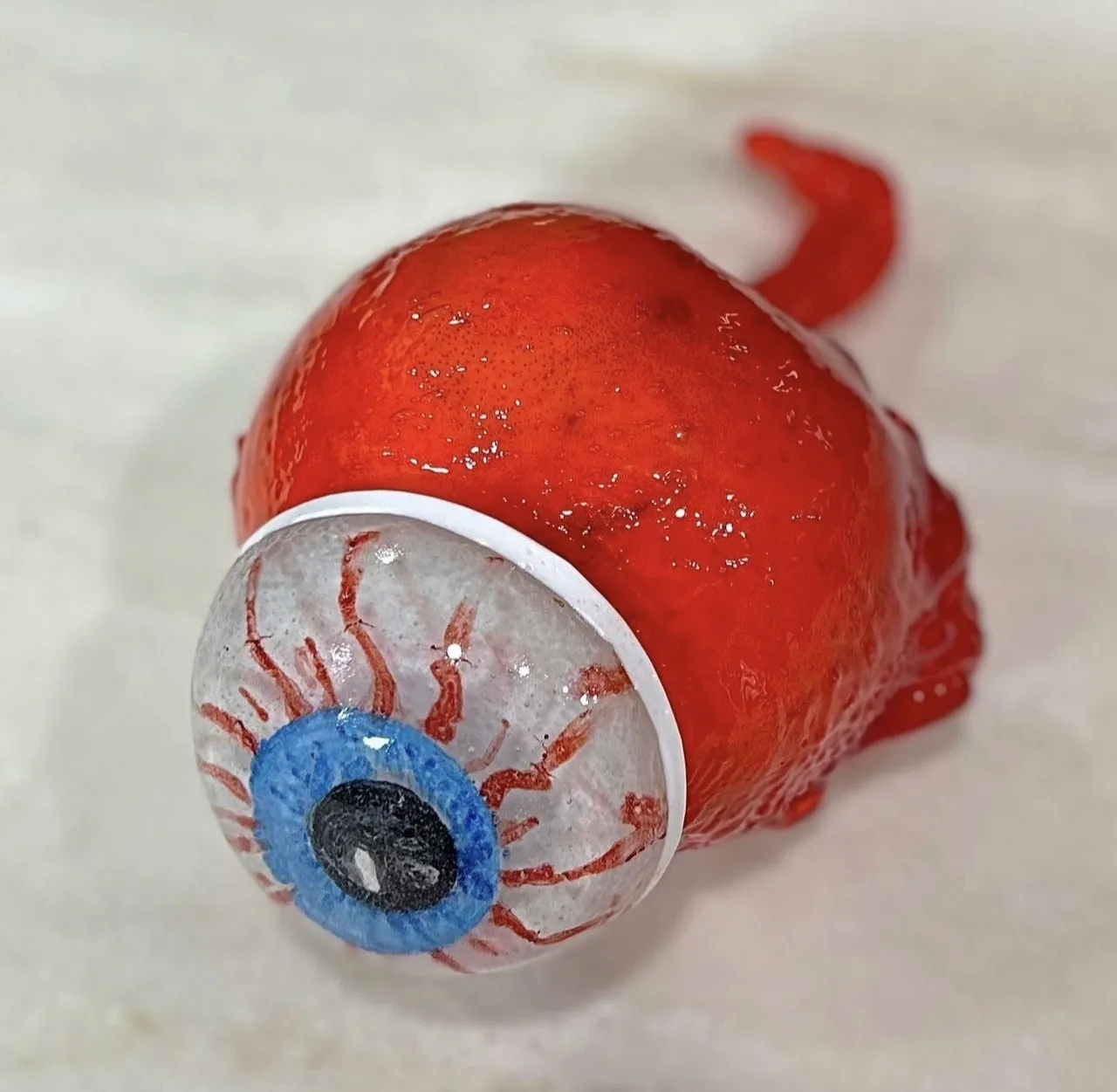 A candy apple decorated to look like a haunted eyeball