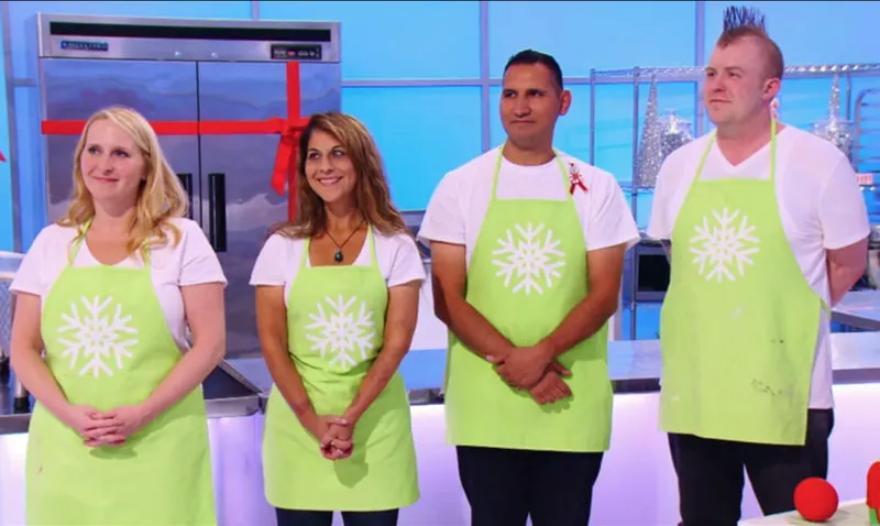 Contestants in matching lime green aprons on the Holiday Wars set.