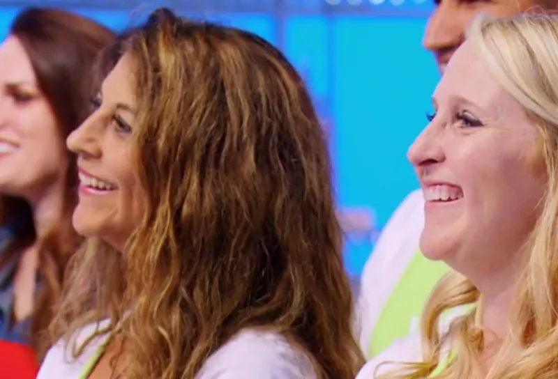 Two smiling women in profile at the Holiday Wars set.