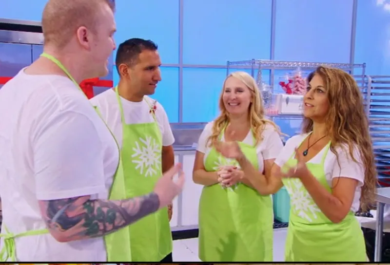 Contestants in lime green aprons in a kitchen studio on Holiday Wars.