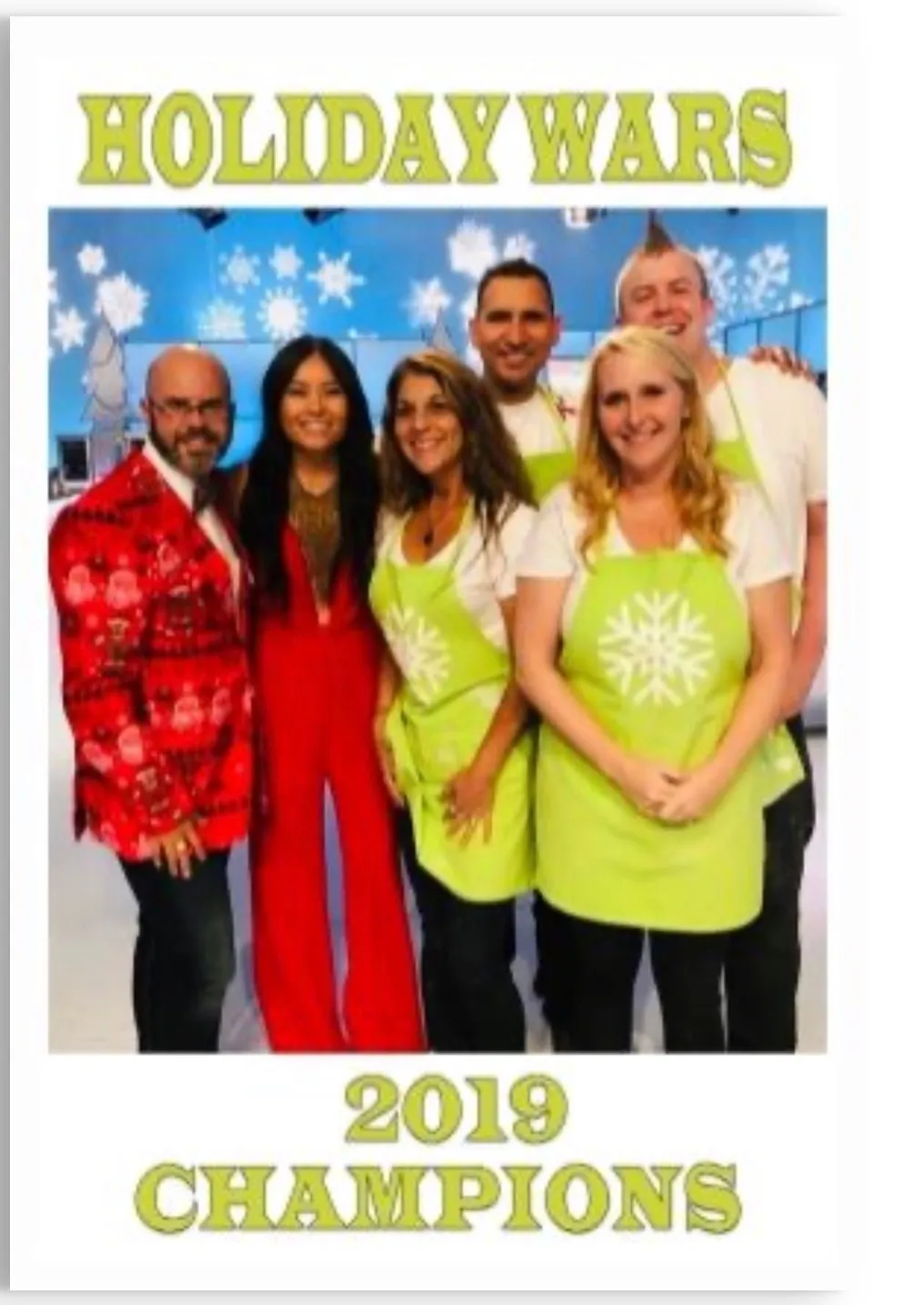 The Holiday Wars 2019 Champions team in front of a blue backdrop.