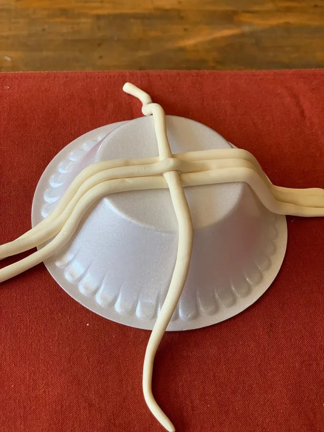 Modeling chocolate strips laid over an inverted bowl