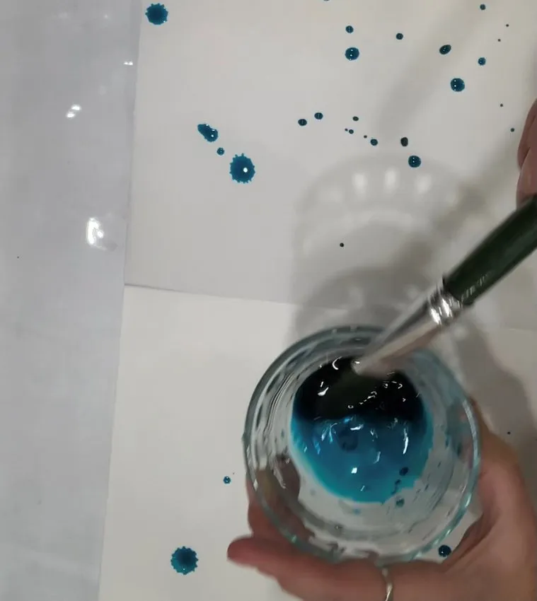 Mixing blue edible colors in small bowls.
