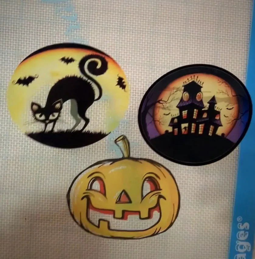 Three Halloween edible cello sheets with black cat, haunted house, and jack-o'-lantern.