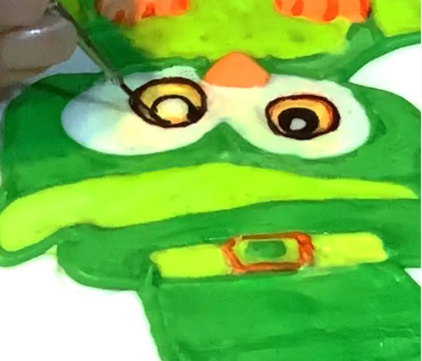 Painting eyes and details with a small brush.