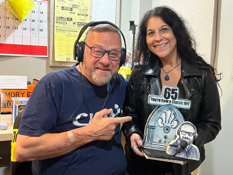 Paul Ciliberto holding a custom birthday plaque featuring a jukebox and caricature.