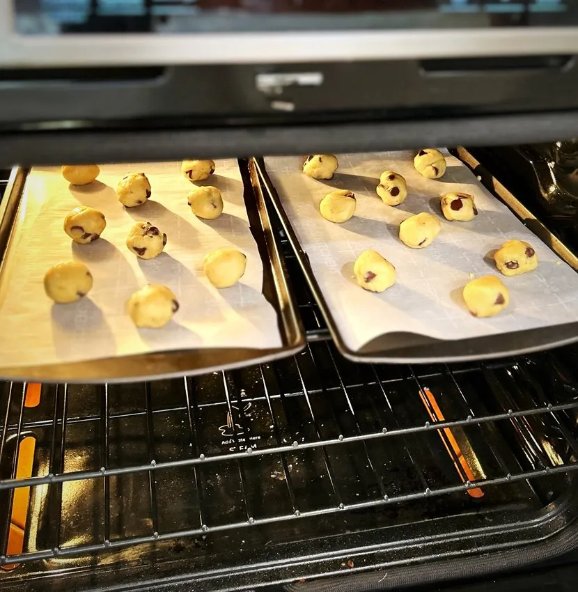Baking sheets of cookie dough in the oven