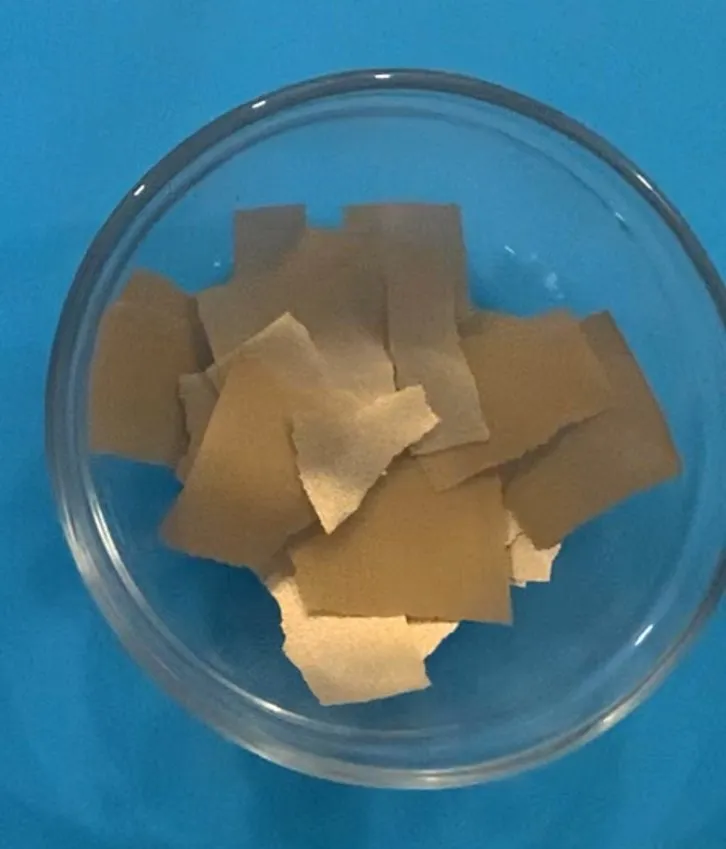 Glass bowl filled with torn pieces of edible fabric sheet.