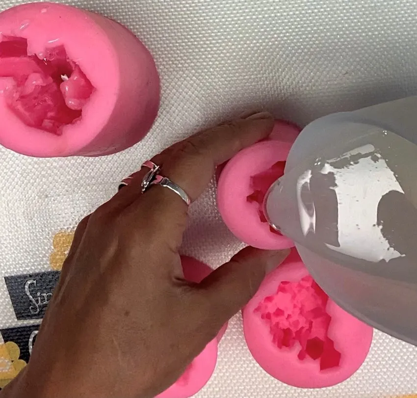 Pouring clear melted isomalt into a gemstone silicone mold.