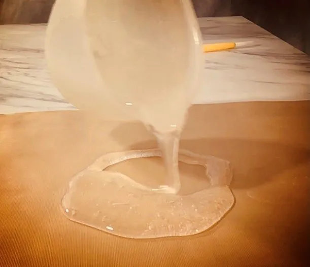 Pouring clear isomalt to form an ice block base.