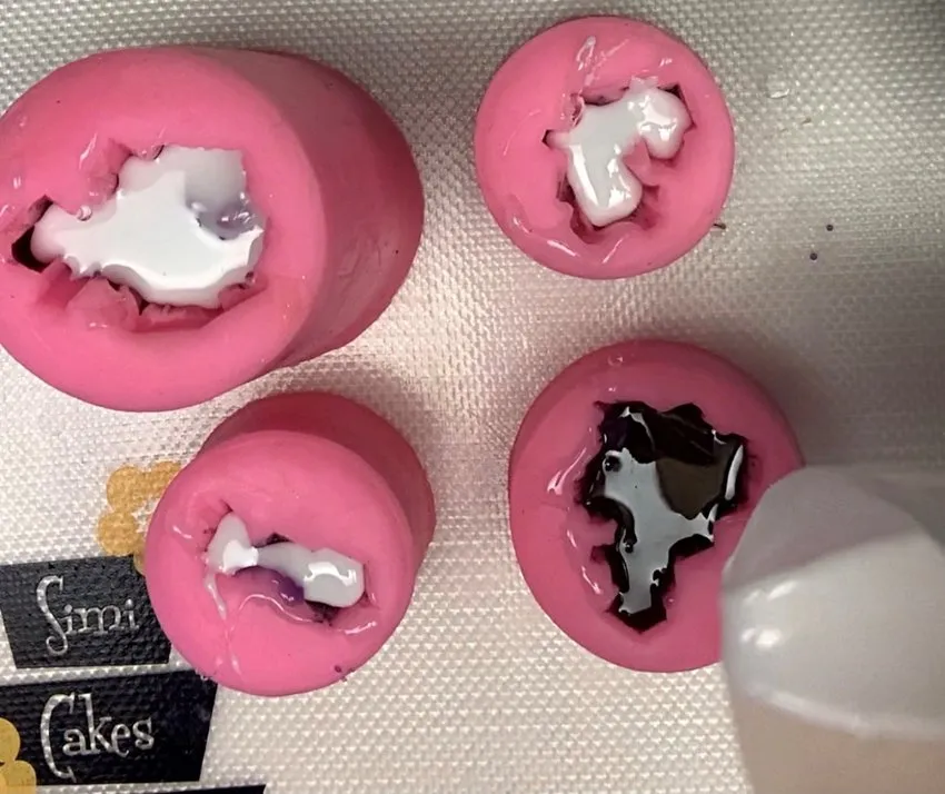 Layering white and black isomalt in gemstone silicone molds.