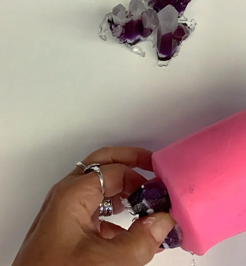 Holding a finished purple isomalt crystal removed from the mold.