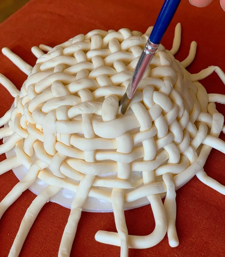 Sculpting the rim of the woven chocolate basket