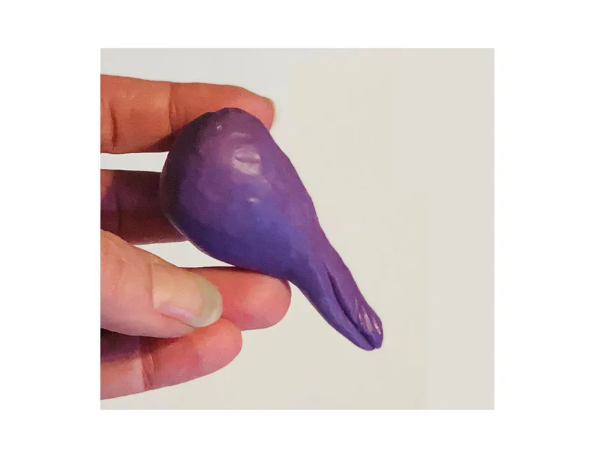 Purple modeling chocolate shaped into a teardrop for the lovebird body.