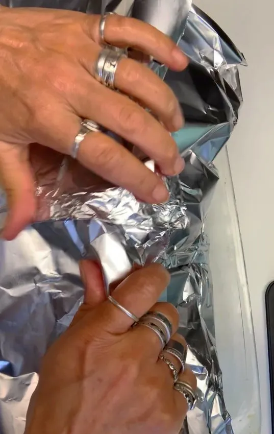 Covering the pan with aluminum foil